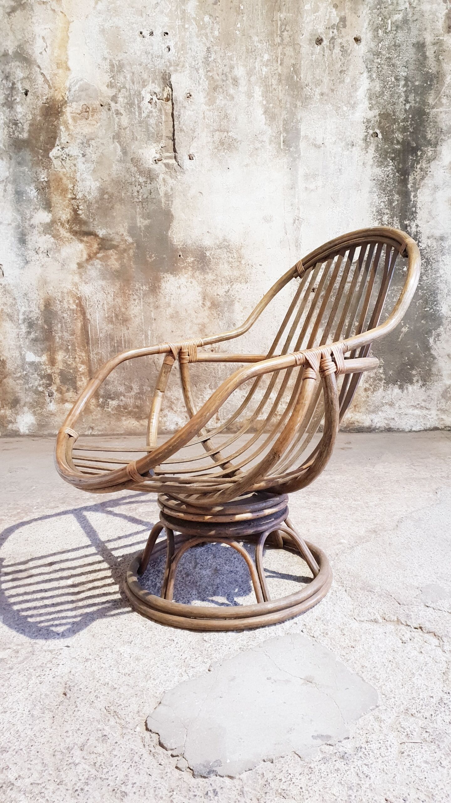 Antique swivel rattan armchair