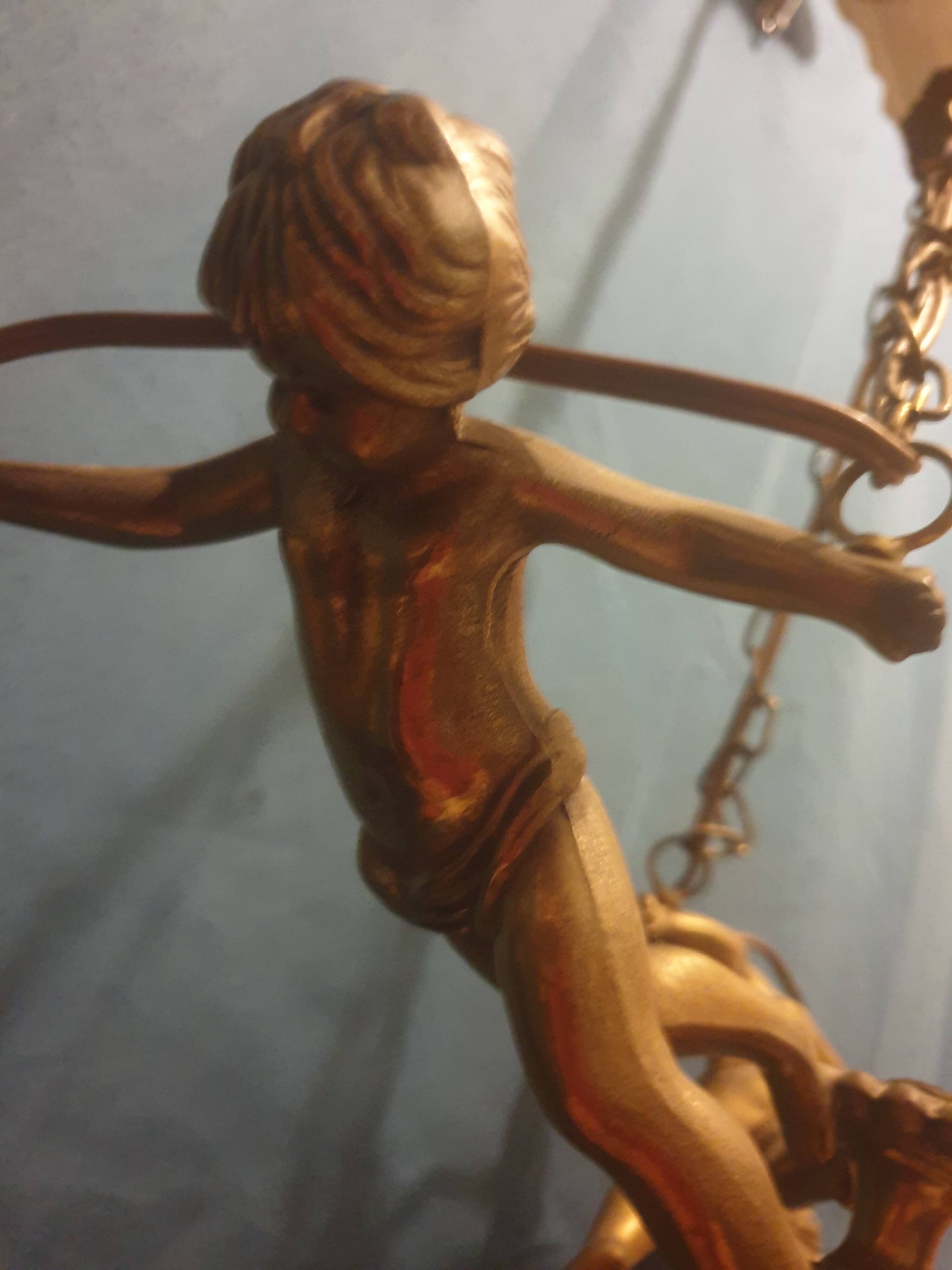 Antique chandelier decorated with cherubs and putti angels taken from the attic