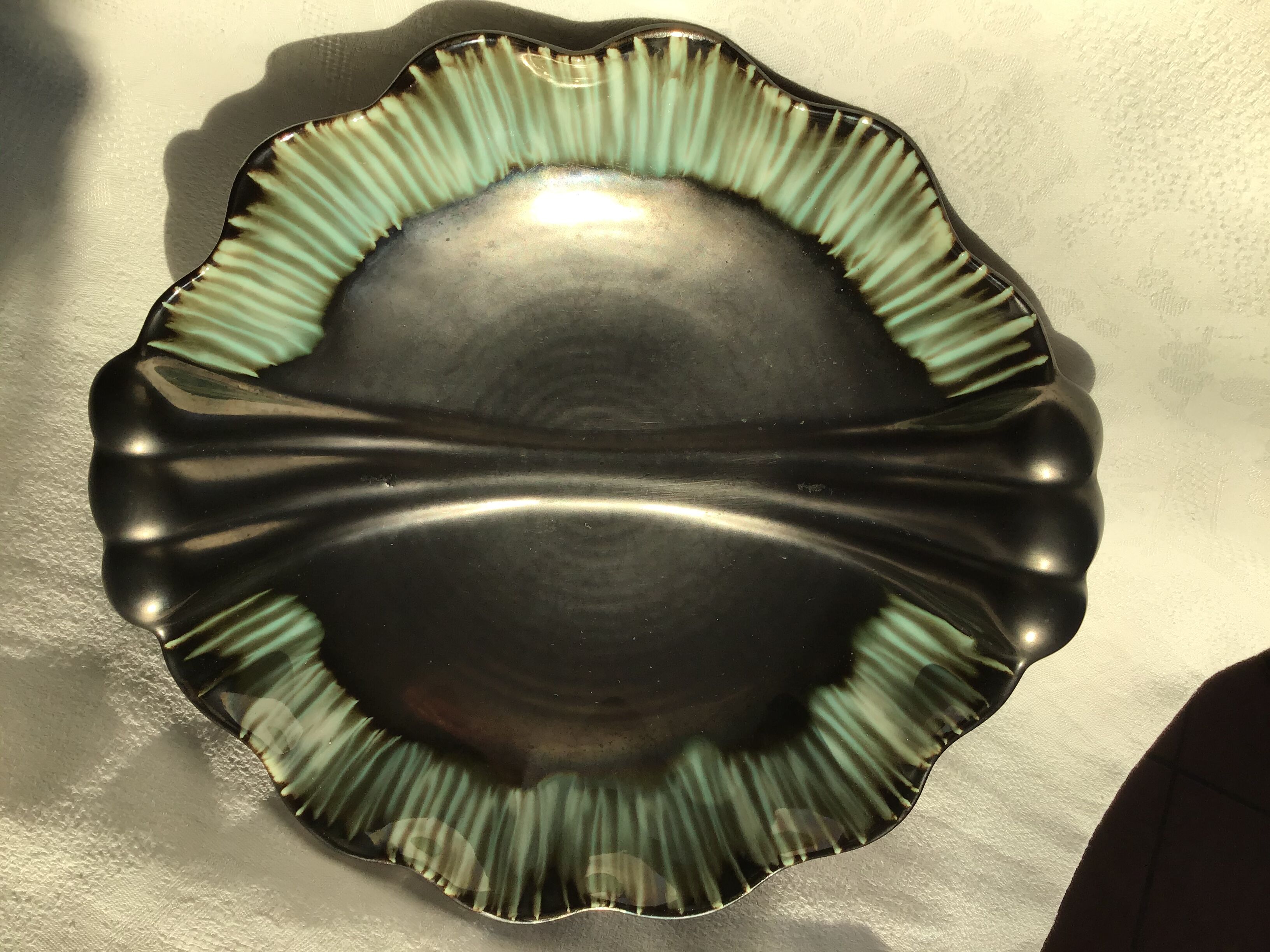 Undulating black iridescent ceramic cut
