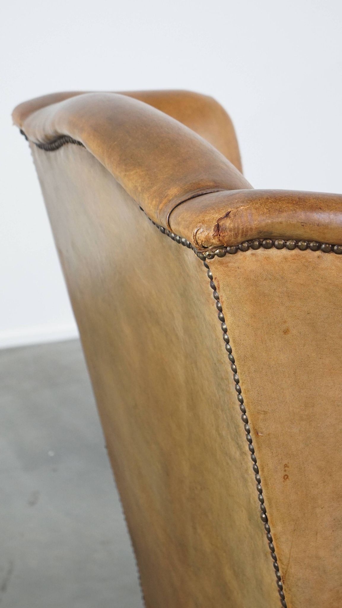 Patinated sheep leather wingback armchair