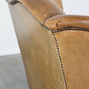 Patinated sheep leather wingback armchair