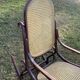 Thonet rocking chair in curved brown wood, period seat, 19th-century bentwood style.