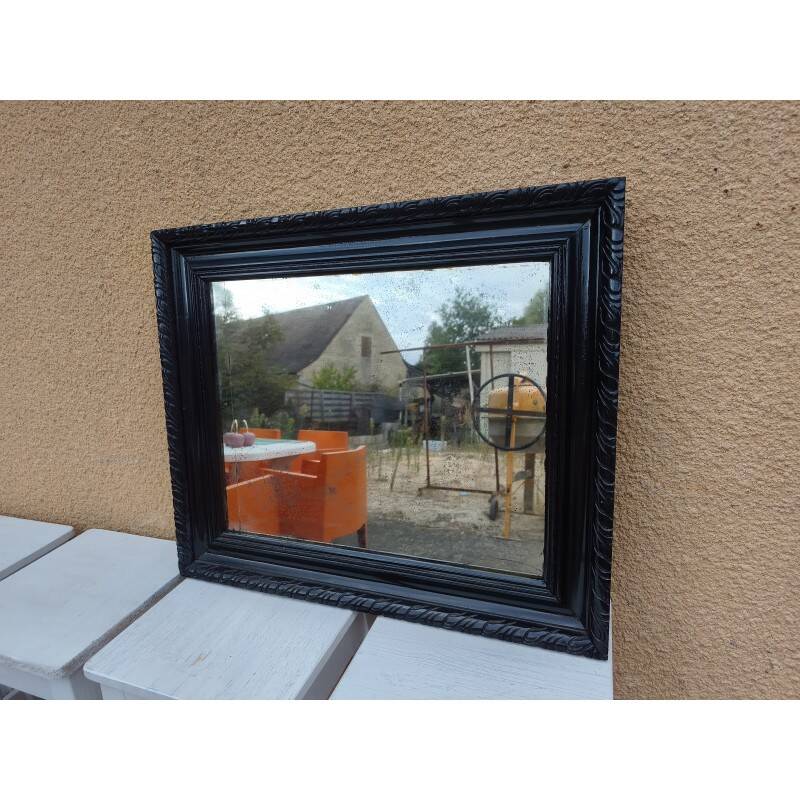 Black lacquered wood mirror "originally punctured"
