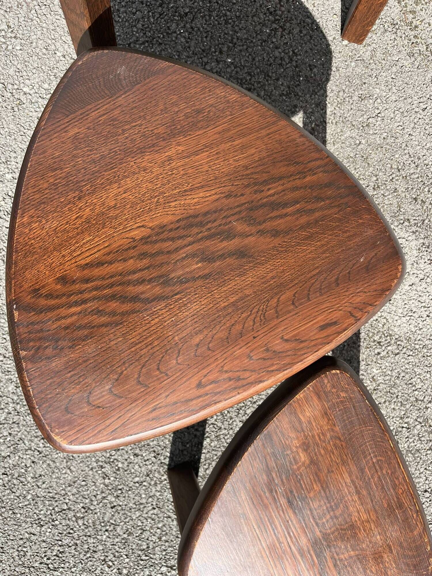 Nested tripod tables made of solid wood, in a modernist brutalist style.