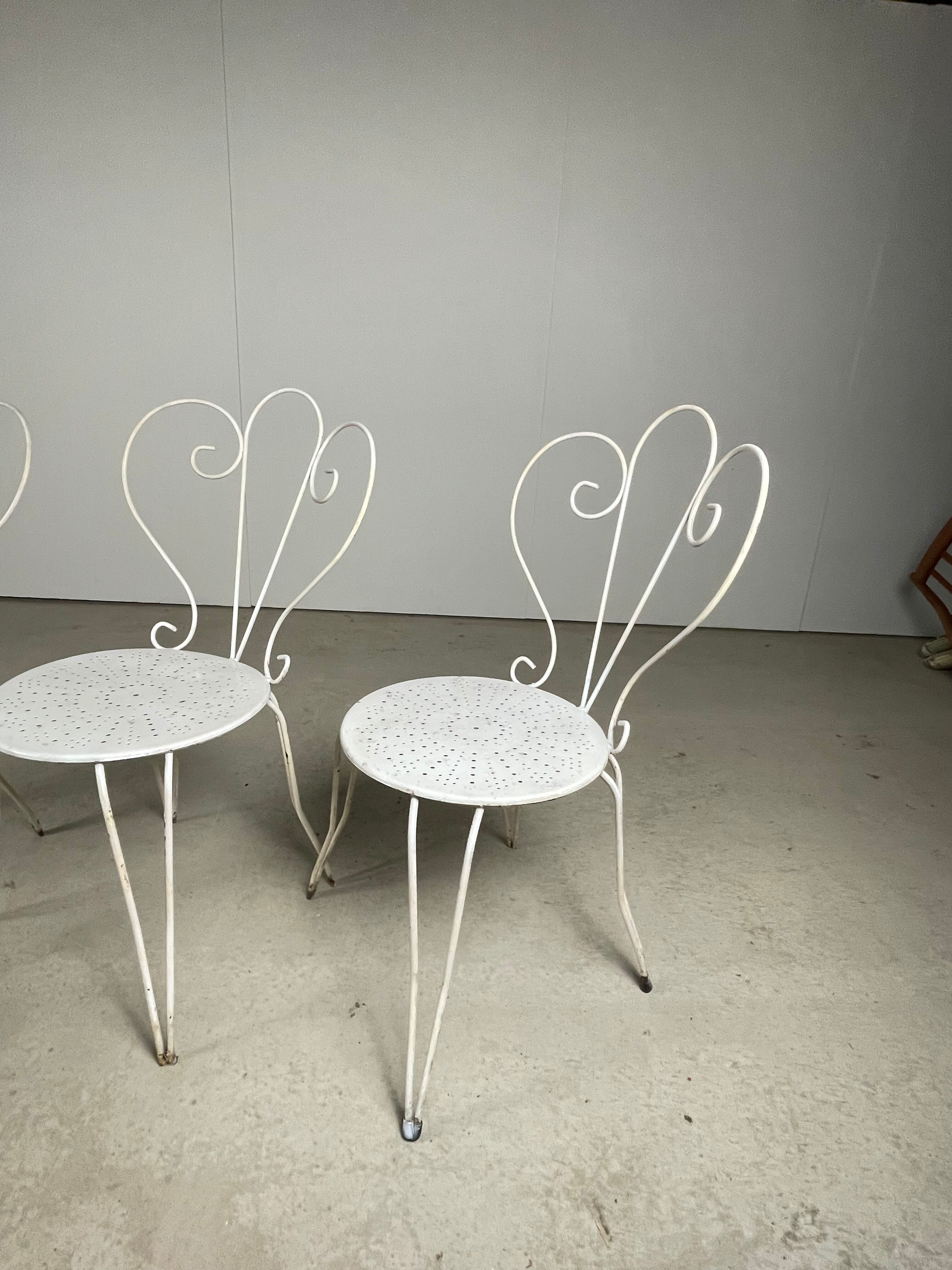 4 vintage wrought iron chairs
