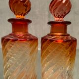 Pair of Baccarat twisted tinted crystal bottles