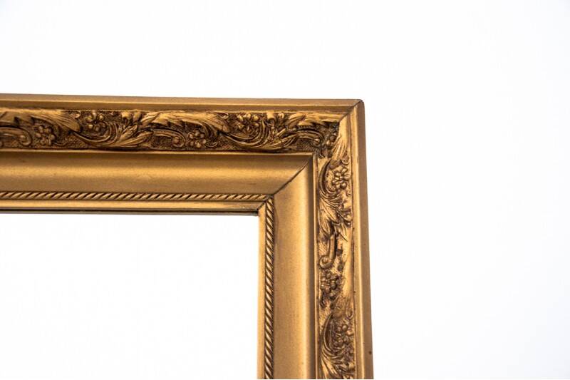 A mirror in a golden frame