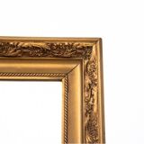 A mirror in a golden frame