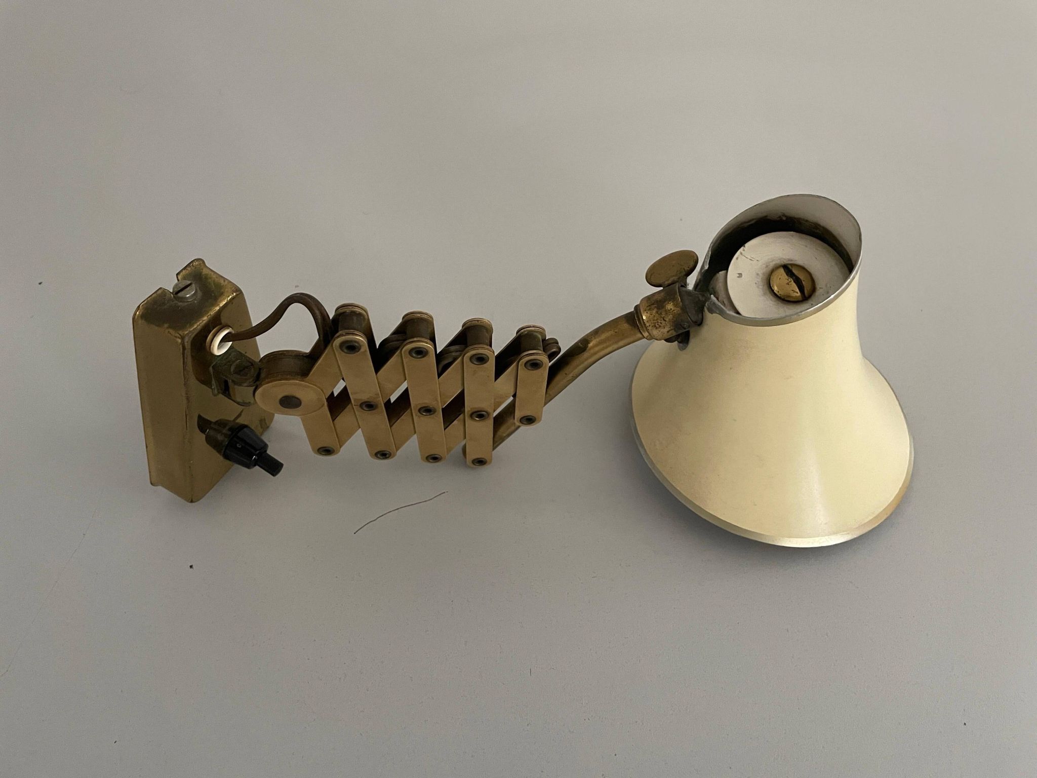Cream metal and brass wall lamp with scissors design by Karl Lang for SIS Licht, 1950s, Germany.