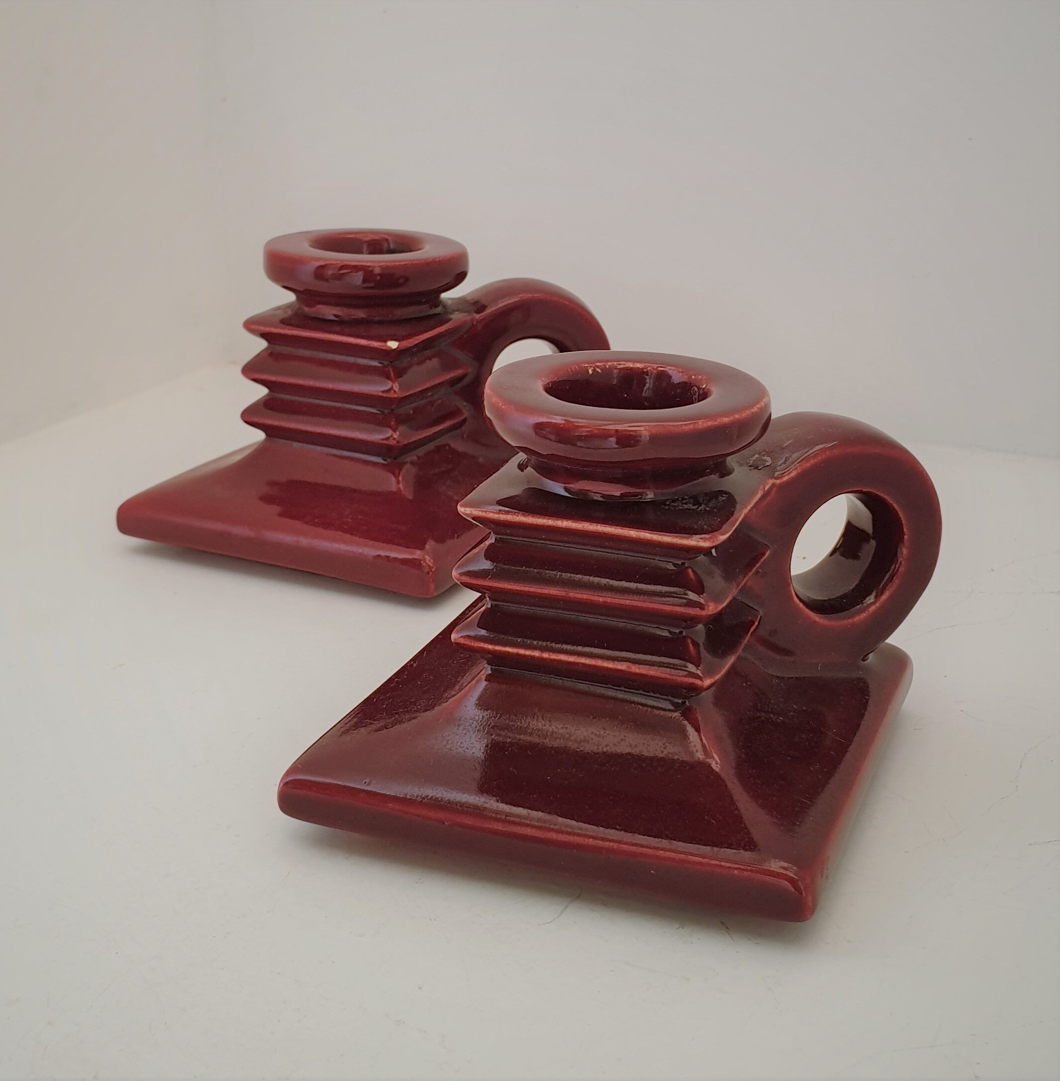 Pair of art deco candlesticks in bordeaux ceramics