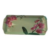 Cake dish with fuchsia orchids