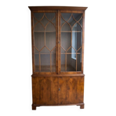 Classic English display cabinet in wood with glass doors.