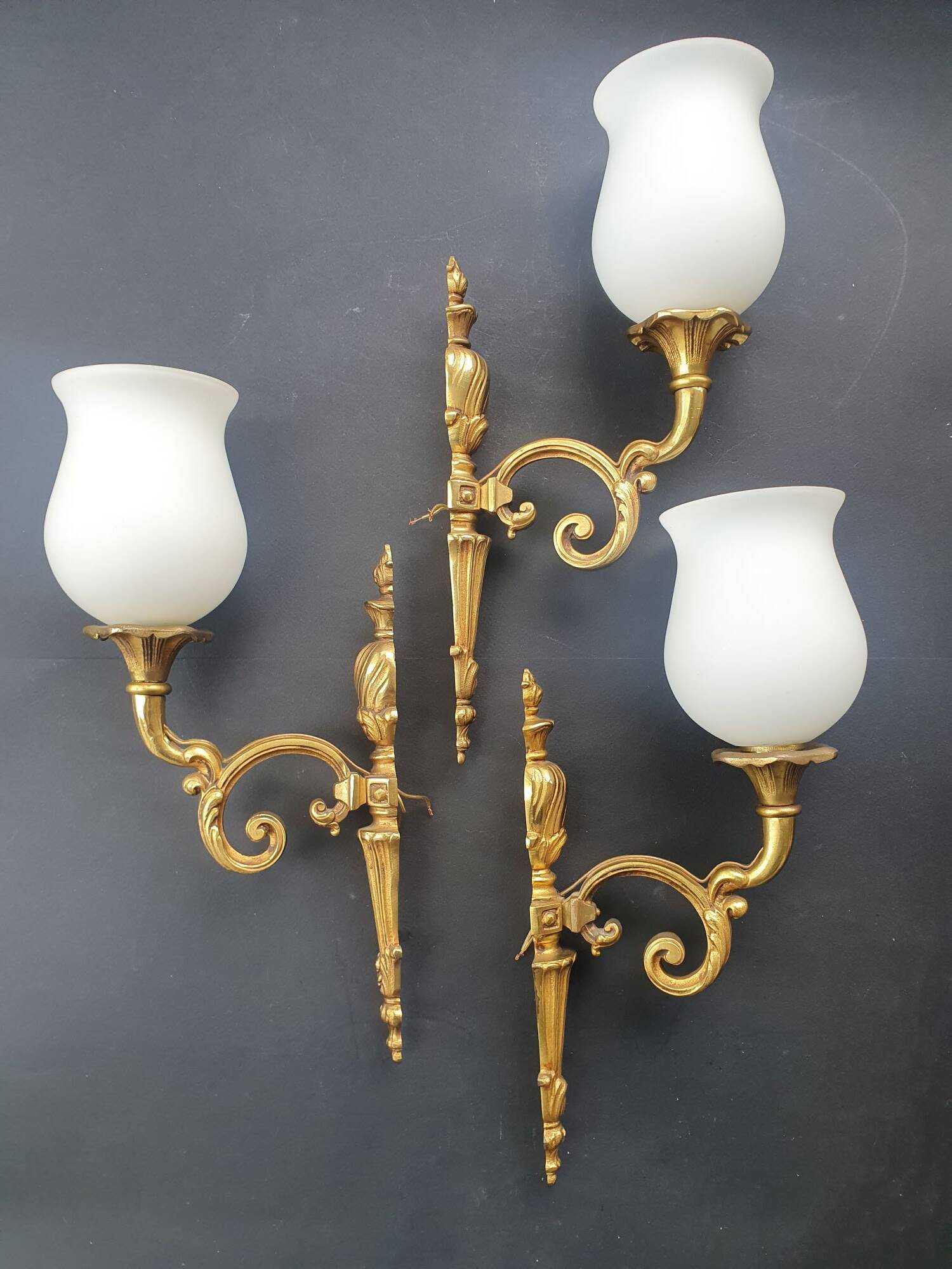 Three large vintage torch wall sconces.