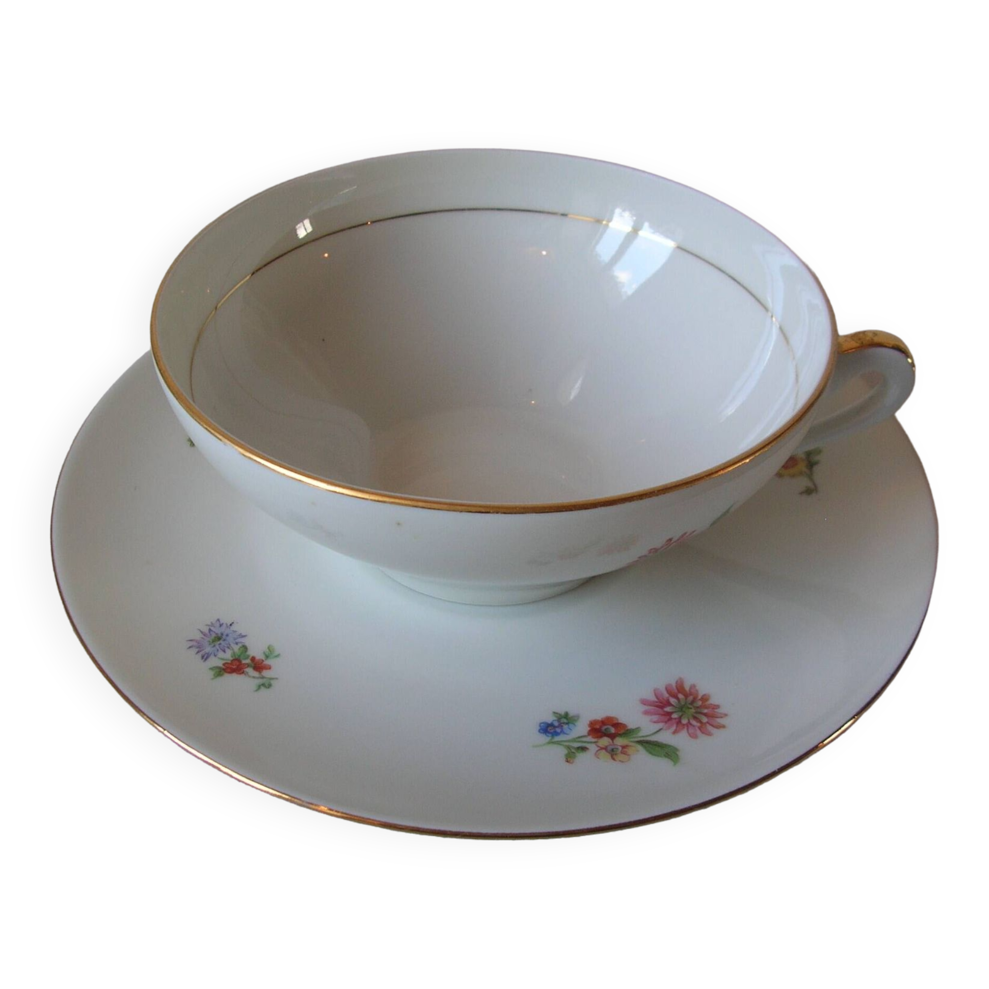 Old large tea cup and saucer in Limoges porcelain with flower decor