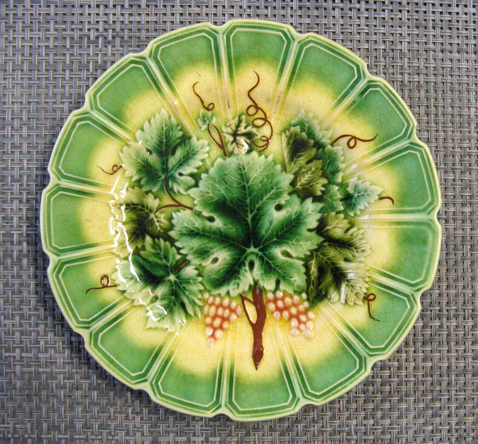 Dessert plate decorated with vine leaves and grapes in slip form.