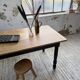 Oak farmhouse table with turned black legs.