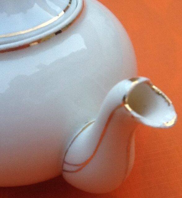 Old porcelain teapot with floral decoration