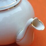 Old porcelain teapot with floral decoration