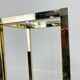 Gilded metal fifth wheel column and Hollywood Regency style glass 70s
