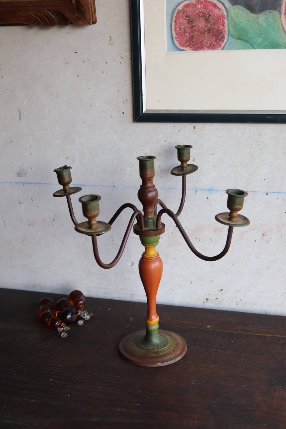 Old candlestick in painted wood and folding metal