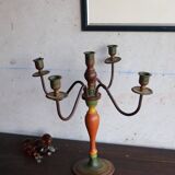 Old candlestick in painted wood and folding metal