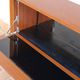 Vintage teak bar cabinet with black glass interior.