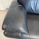 Two-seater Natuzzi sofa in navy blue leather.