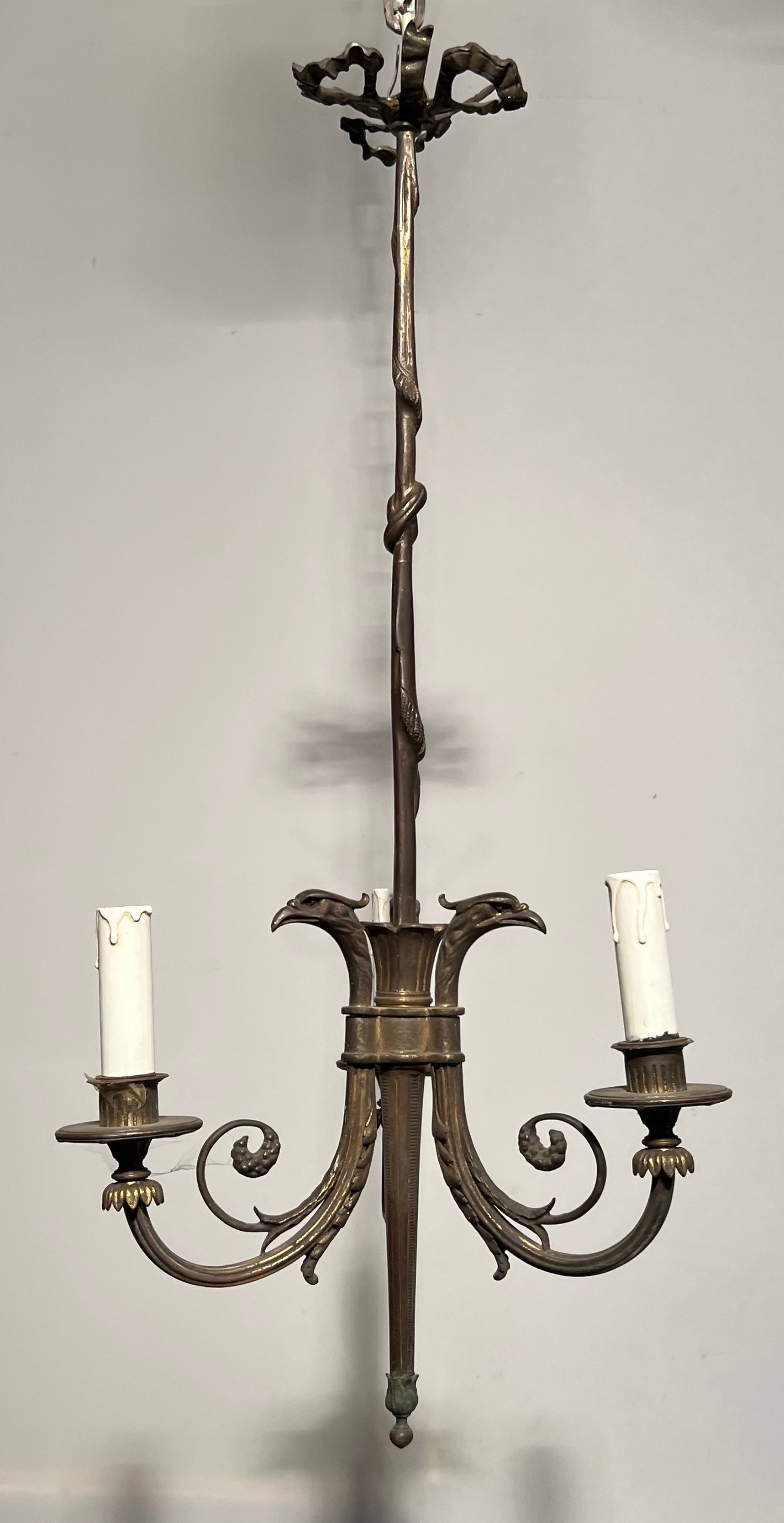 Empire-style bronze chandelier with 3 arms of light topped with eagle heads. French work. Circa 1900.