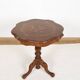 Pedestal table or side table, carved wooden legs, inlaid veneer on the top.