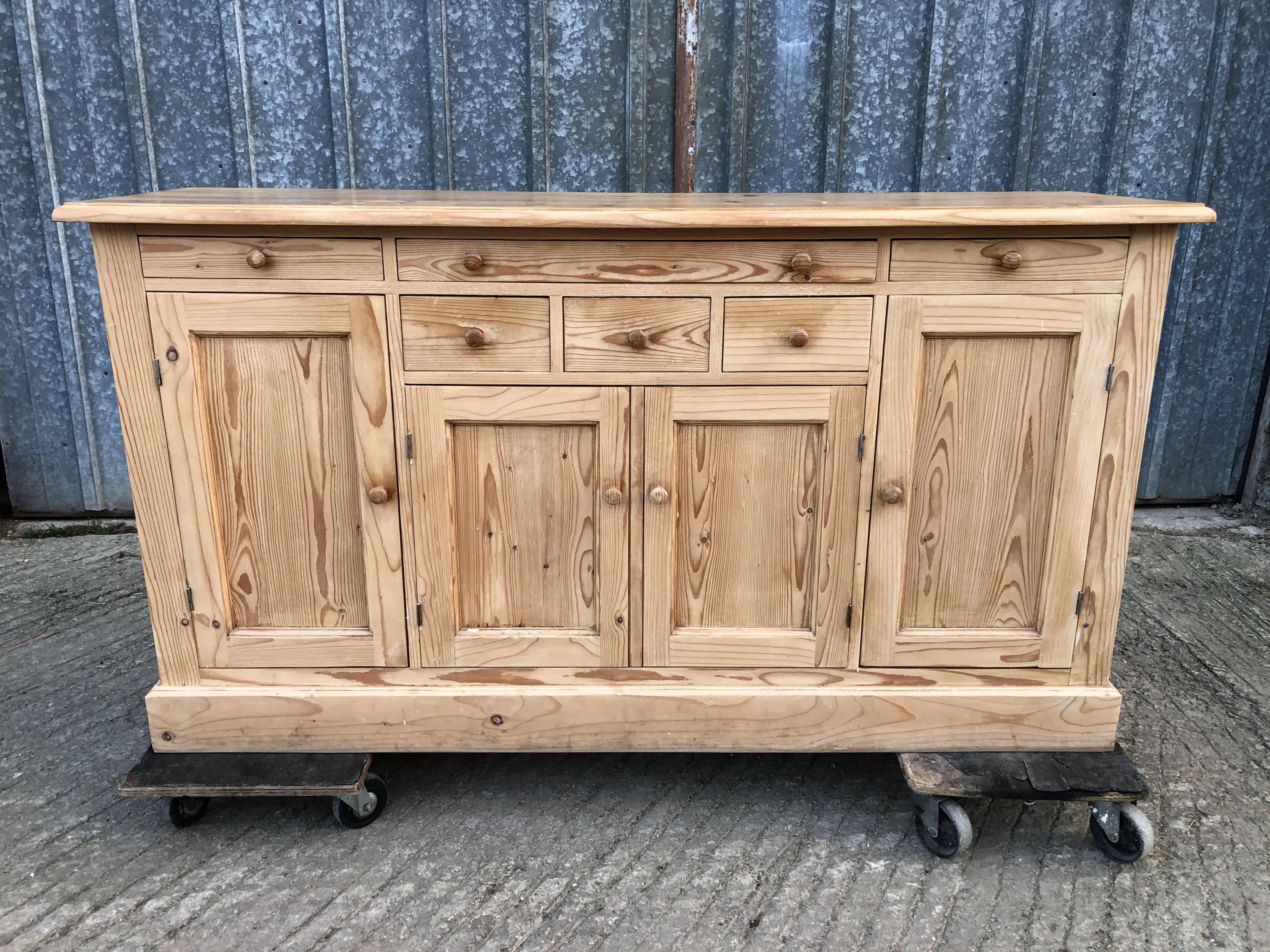 Scandinavian natural pine sideboard with 4 doors and 6 drawers.