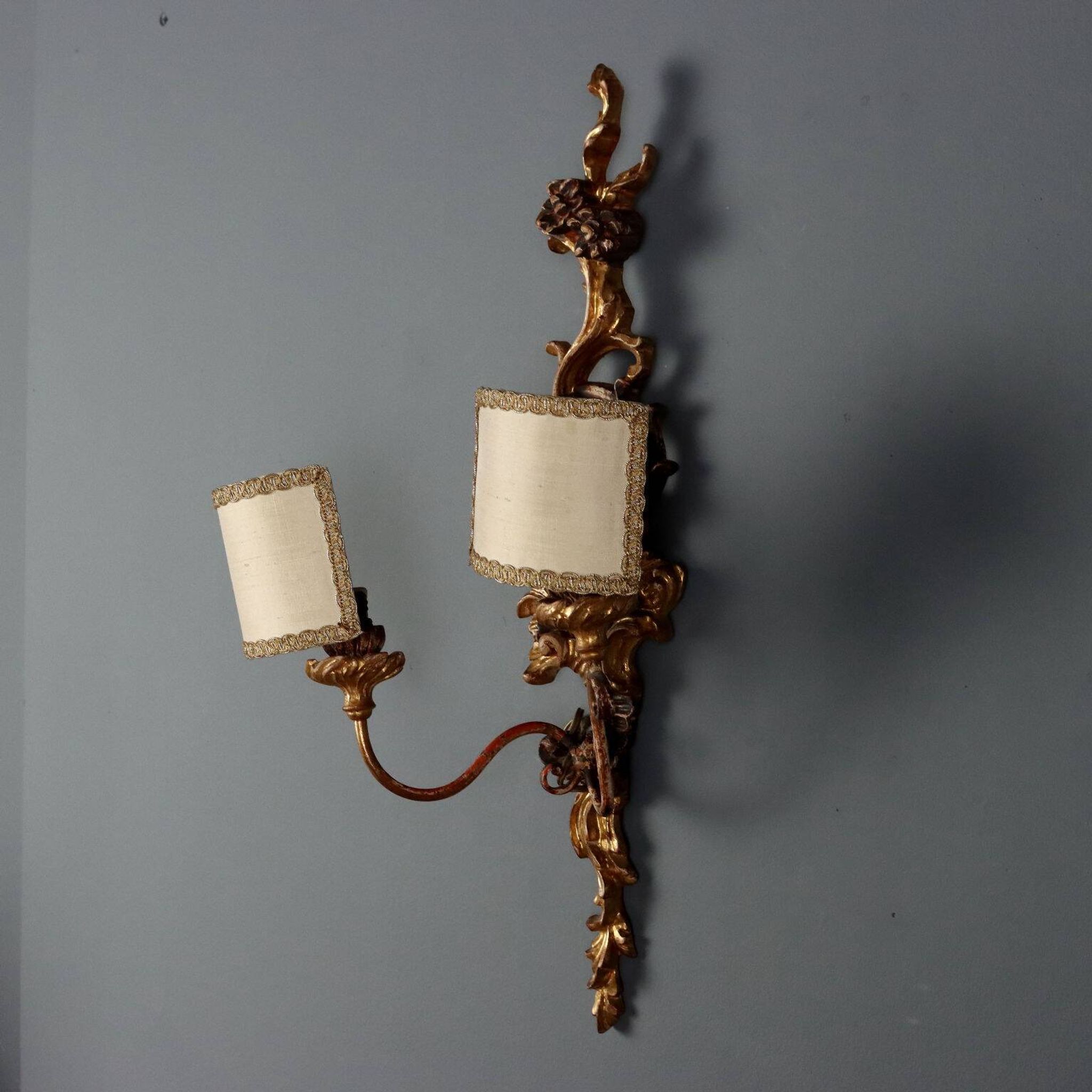 Antique wall sconces in carved lacquered and gilded wood, Italy, 20th century.