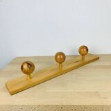 Wall coat rack with pine ball hook