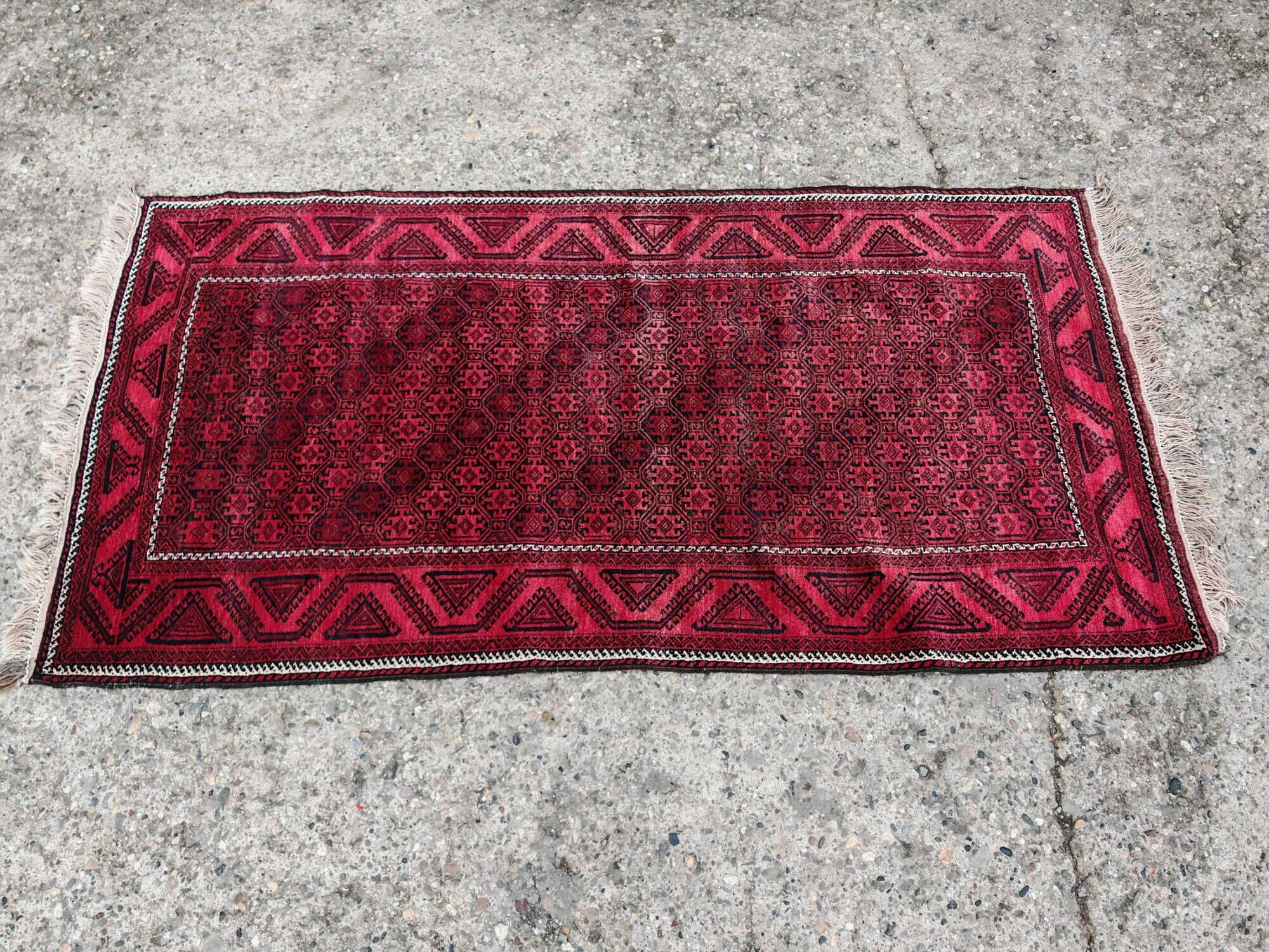 Vintage handmade Baluch rug with geometric pattern from the 1950s.