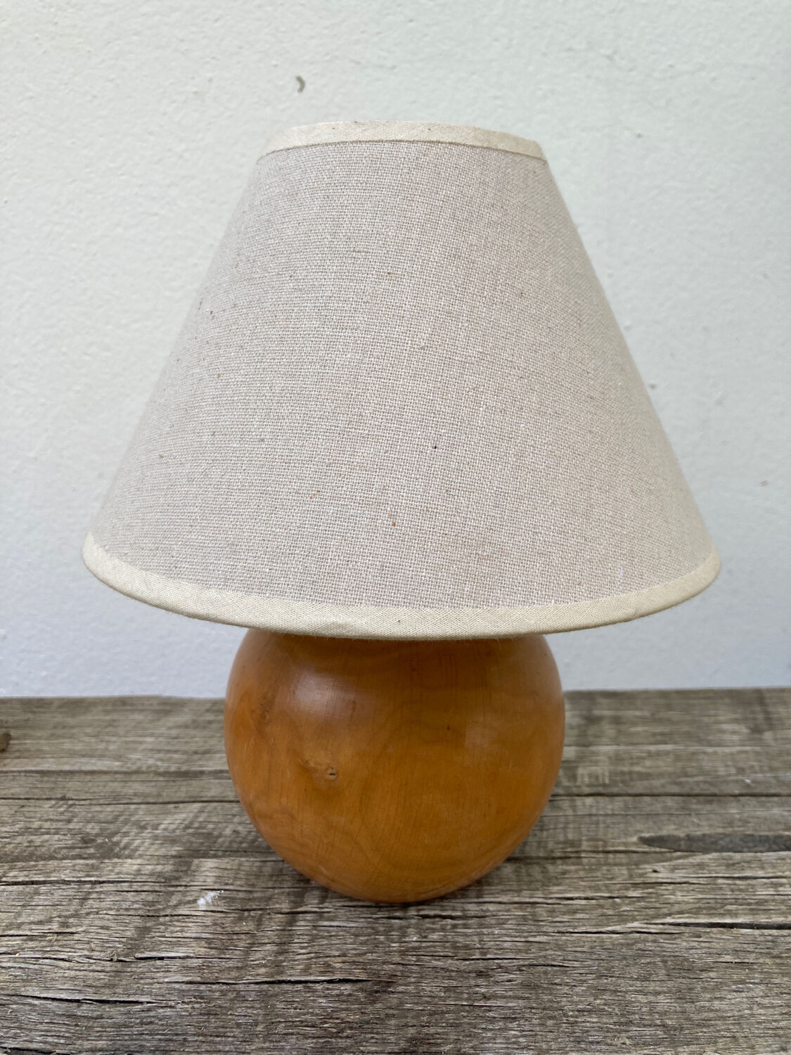 Wooden ball bedside lamp and beige lampshade