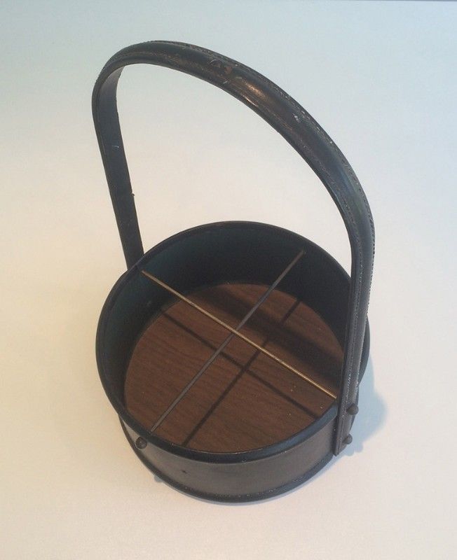 Leather wall magazine rack. In the style of Jacques Adnet.