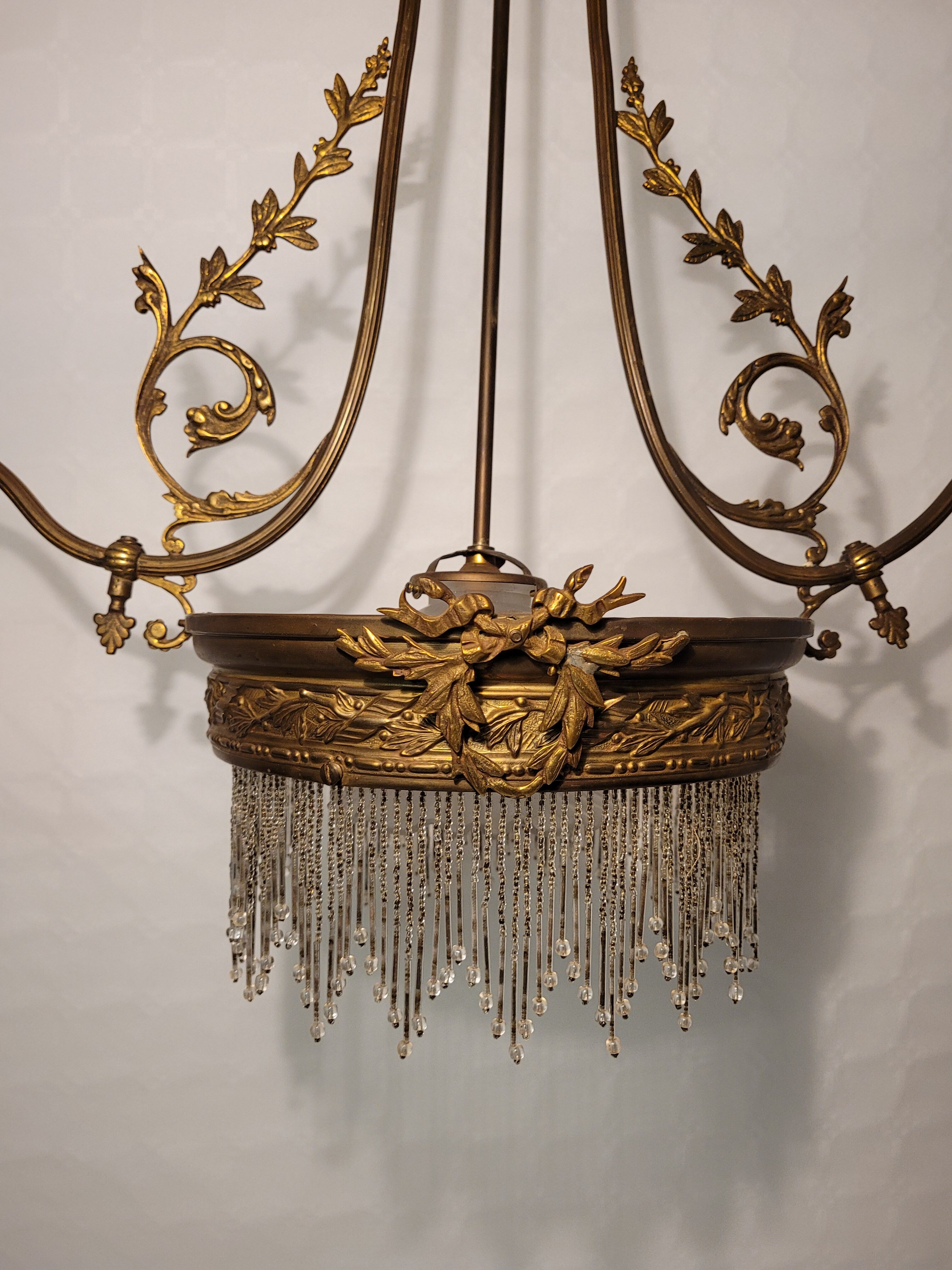 Gold metal chandelier and three-light beads
