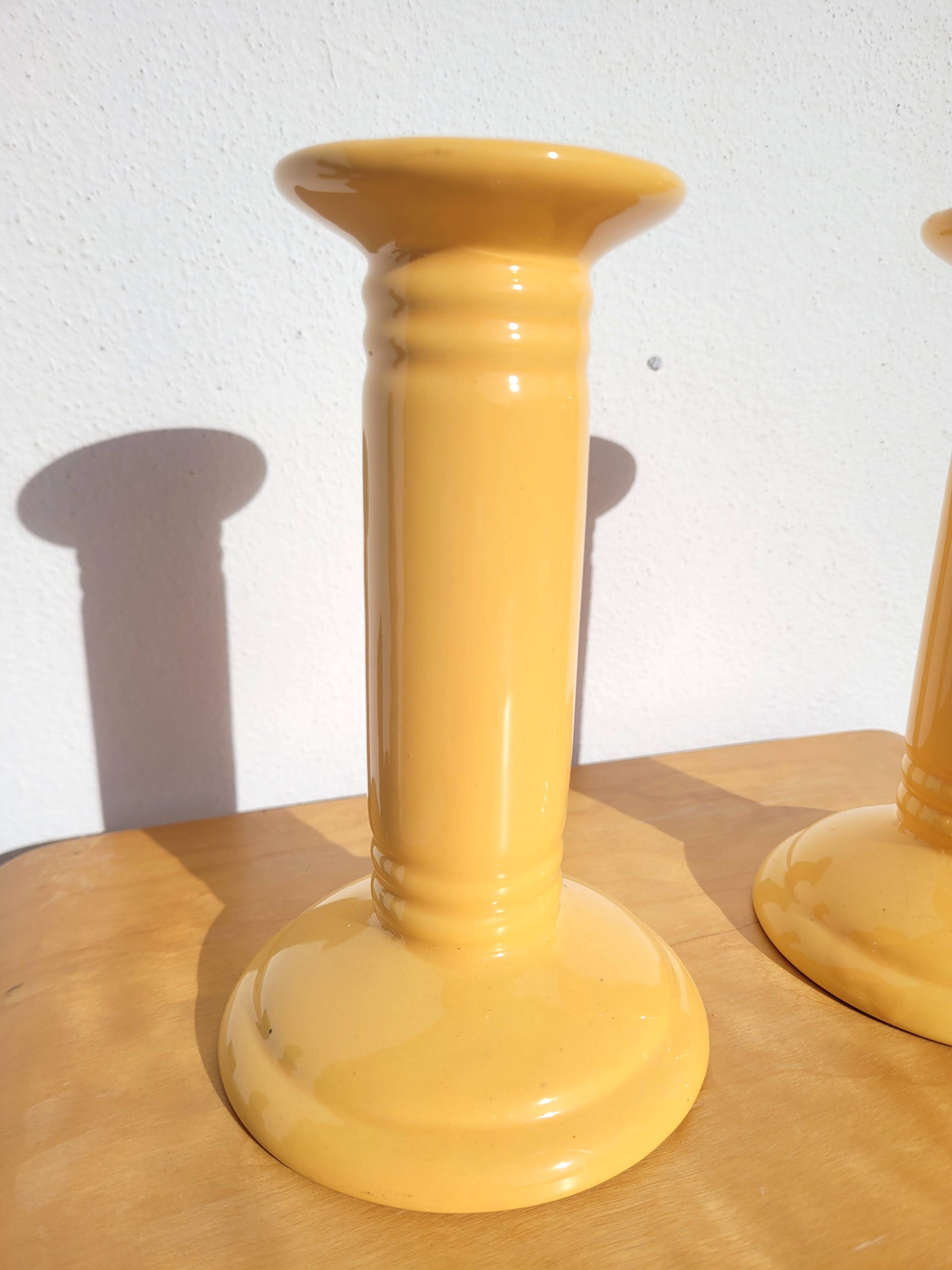Pair of yellow ceramic candlesticks
