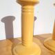Pair of yellow ceramic candlesticks