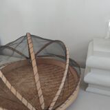 Braided basket with protective mosquito net