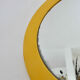 Round wall mounted mirror in yellow plastic 1970