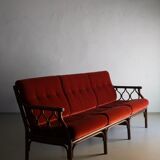Dark rattan 3-seater sofa with red velour cushions | 1980s
