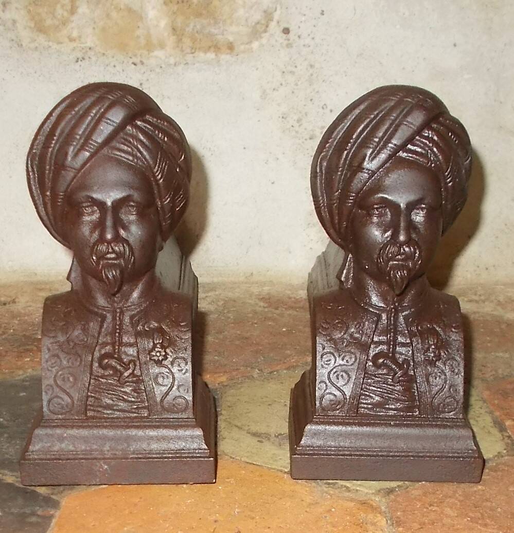 Old cast iron andirons with oriental decor