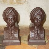 Old cast iron andirons with oriental decor