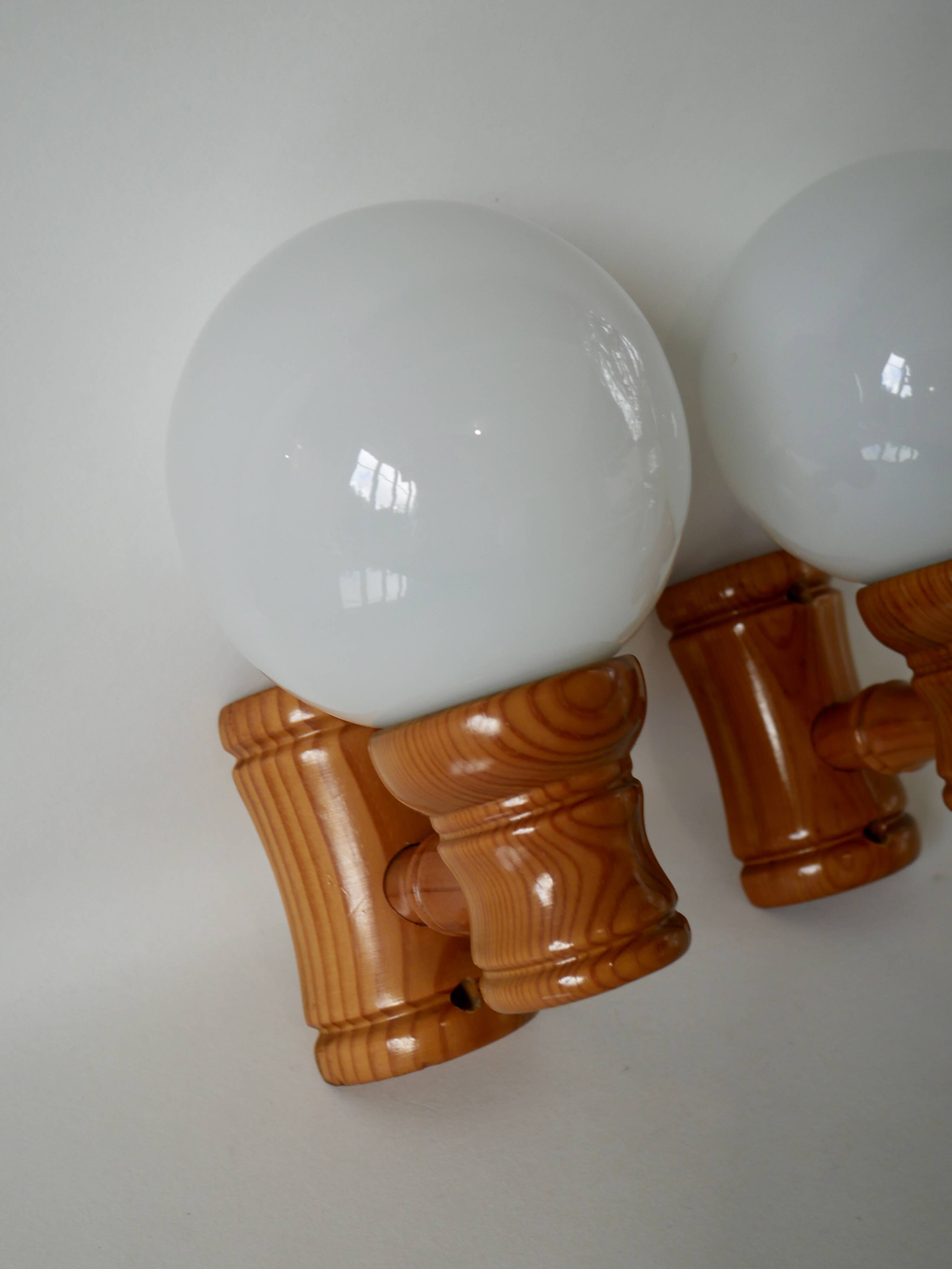 Pair of globe wall lights in pine and opaline from the 60s