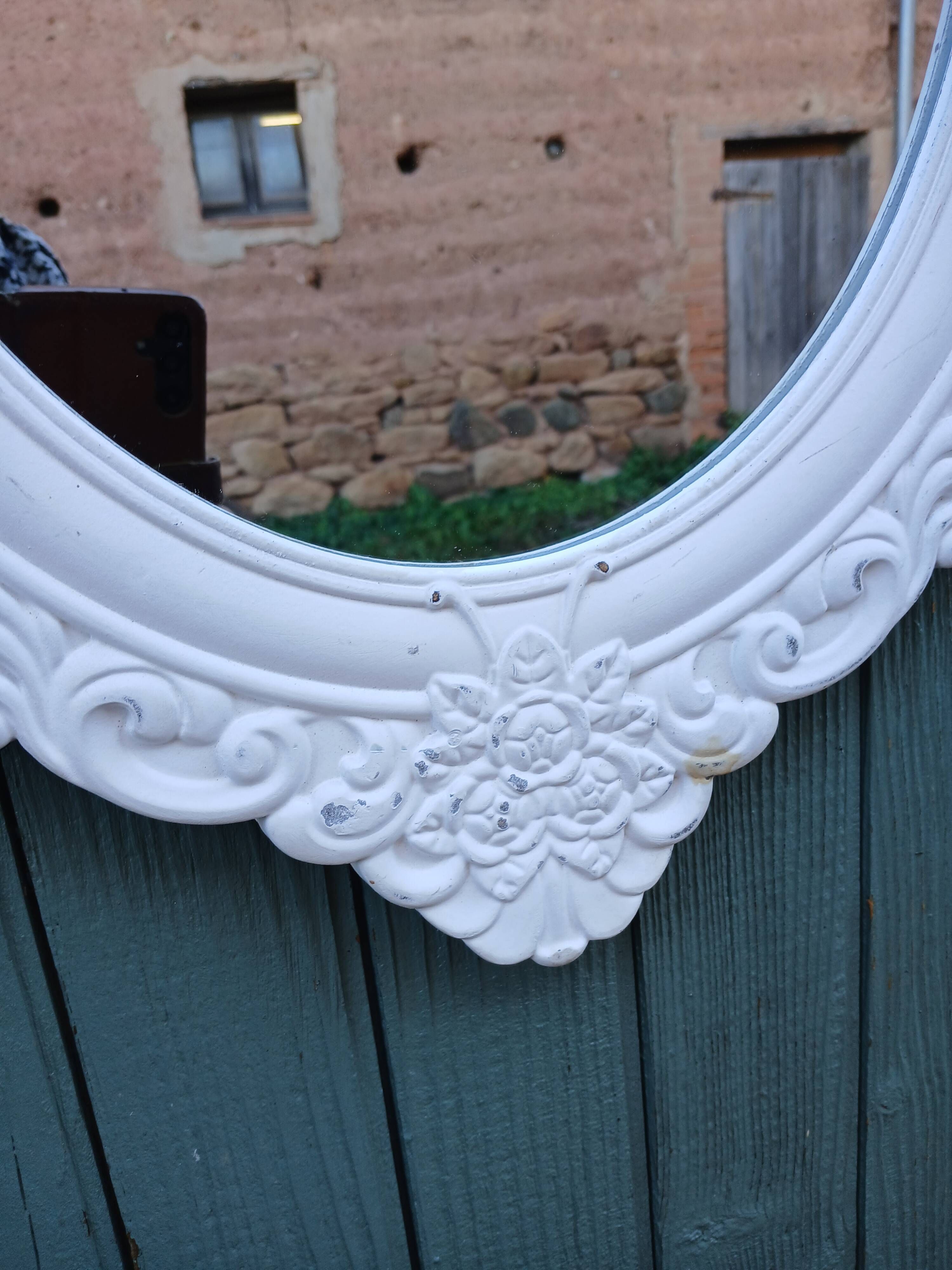 Oval mirror with white frame
