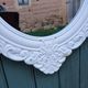 Oval mirror with white frame