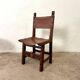 Spanish chair in leather and carved wood, 1950s/60s.