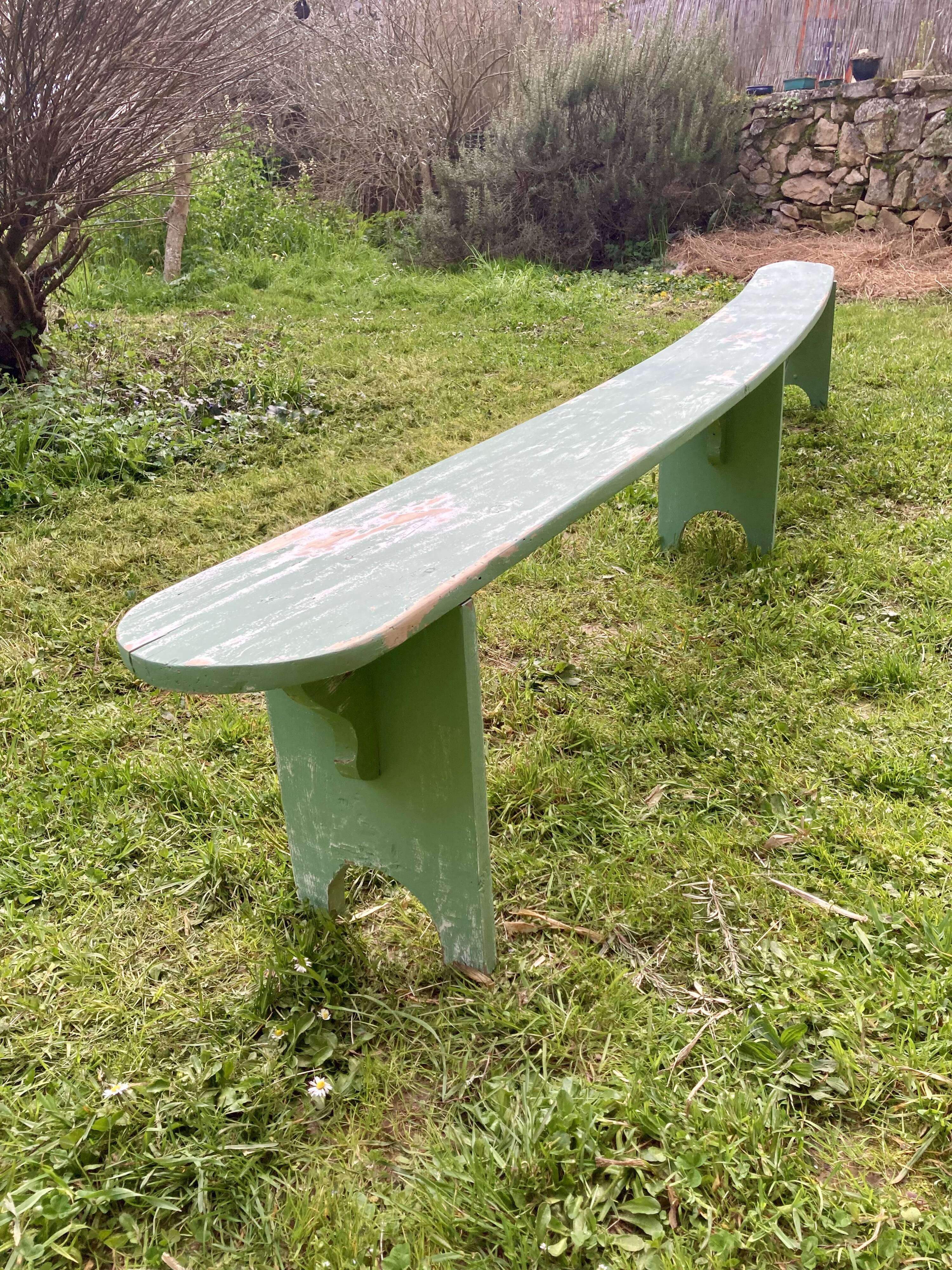 Old curved wooden farm bench