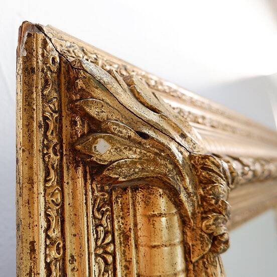 Large gilded wood and stucco mirror with foliage