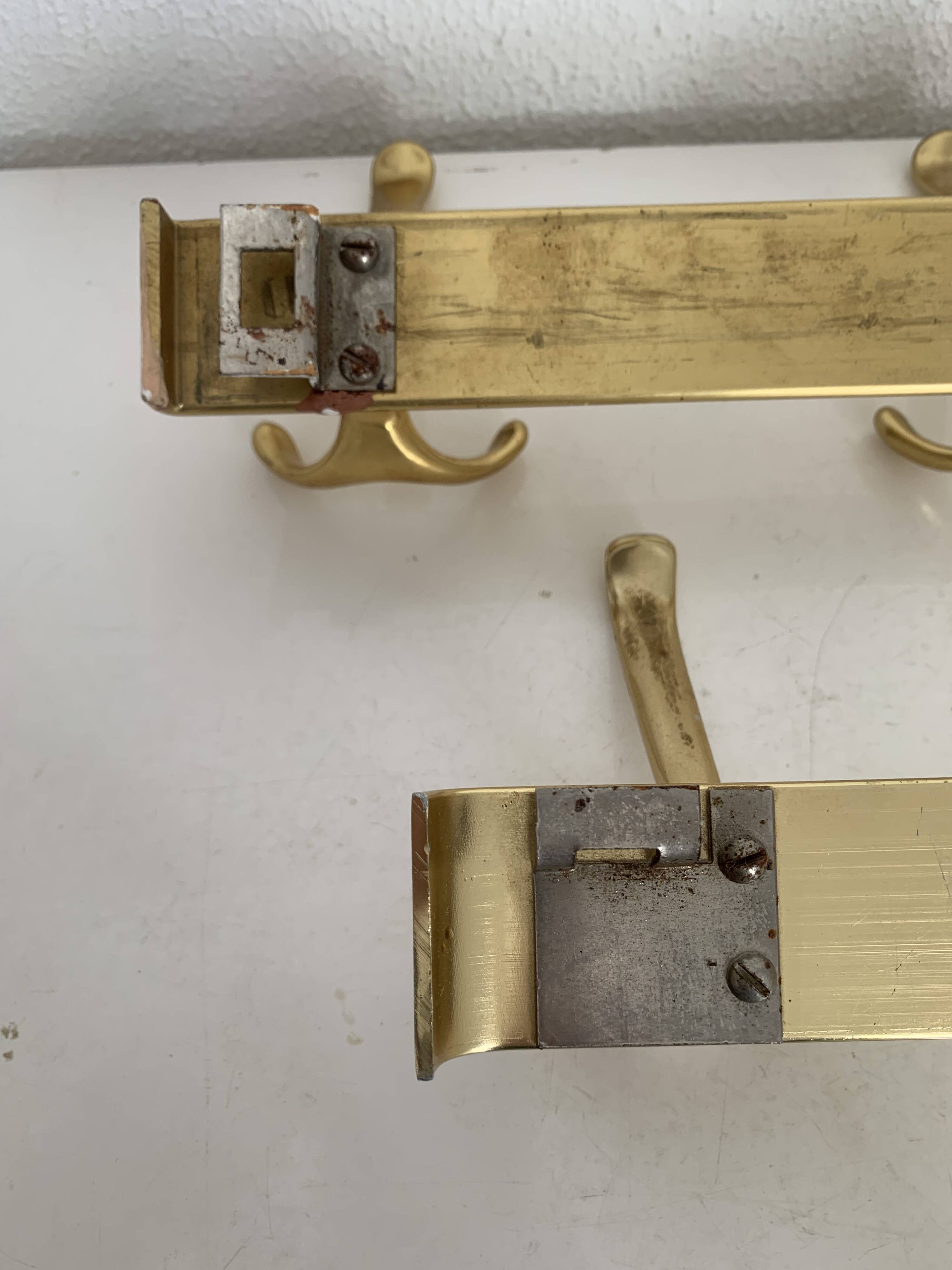 Three vintage 1960s gold coat racks with 4, 3 and 2 hooks